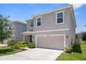 View of the house and the surrounding area with the gray house and a big driveway at 2449 Moon Shadow Rd, New Port Richey, FL 34655
