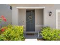 Inviting front door with a decorative wreath and fresh landscaping at 2449 Moon Shadow Rd, New Port Richey, FL 34655