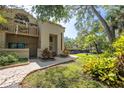 Charming home exterior showcasing beautiful landscaping and a well-manicured lawn at 307 Los Prados Dr # 307, Safety Harbor, FL 34695