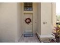 Inviting front door with wreath, house number, and a decorative welcome mat at 307 Los Prados Dr # 307, Safety Harbor, FL 34695