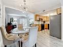 Open concept dining room featuring a glass table and chairs, open to the kitchen and living area at 3620 41St S Way # B, St Petersburg, FL 33711