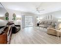 Bright living room with plank floors, a ceiling fan, and sliding glass doors leading to the lanai at 3620 41St S Way # B, St Petersburg, FL 33711