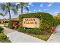 Entrance sign for Salem Village amidst lush greenery and landscaping, creating a welcoming community atmosphere at 3762 Darston St, Palm Harbor, FL 34685