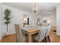 Elegant dining room with a modern chandelier, and a view of the kitchen, perfect for Gathering meals and entertaining guests at 39542 Friends Ave, Zephyrhills, FL 33540