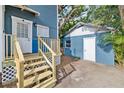 The backyard features a new wood staircase to the home and a matching exterior storage shed with white trim at 4016 N Seminole Ave, Tampa, FL 33603
