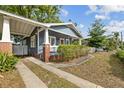 Charming blue home features a covered porch and driveway, adding to the curb appeal of this lovely property at 4016 N Seminole Ave, Tampa, FL 33603