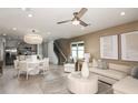 Bright, open-concept living space featuring stylish furnishings, neutral decor, and seamless transition to the kitchen area at 4221 Goldfoil Rd, Spring Hill, FL 34609