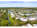 Aerial view of a waterfront residential community with mature trees and serene waterways at 4305 Summersun Dr, New Port Richey, FL 34652