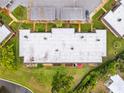 Aerial view shows roof and lawn space, landscaping, patio, and car park of the condo at 4305 Summersun Dr, New Port Richey, FL 34652