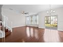 Bright living room featuring hardwood floors, natural light from windows, and a staircase leading to the upper level at 5176 6Th N St, St Petersburg, FL 33703