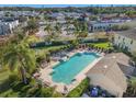 Aerial view of a community pool with lounge chairs and manicured landscaping, offering a relaxing outdoor space at 5176 6Th N St, St Petersburg, FL 33703