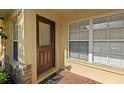 Close up of townhome front door with brick entryway and neutral colors at 6250 Maisie Rd, Zephyrhills, FL 33542