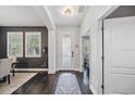 Inviting foyer with dark wood floors, decorative rug, elegant lighting, and views into the dining room at 7307 S Trask St, Tampa, FL 33616