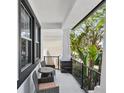 Cozy front porch with seating, decorative pillars, and stylish railing, perfect for relaxing outdoors at 7307 S Trask St, Tampa, FL 33616