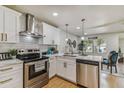 Beautiful kitchen featuring stainless steel appliances, white cabinets, subway tile backsplash, and bright lighting at 8704 N Brooks St, Tampa, FL 33604