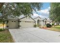 Spacious home featuring an attached two car garage, lengthy driveway, and manicured lawn at 9422 Clover Glen Dr, Riverview, FL 33569