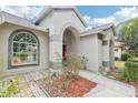 Close up of the home's light colored exterior with arched windows and entryway at 9422 Clover Glen Dr, Riverview, FL 33569