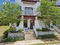 Attractive entryway with brick planters, modern white handrails, and steps leading to the front door at 946 Highland Ave # 24, Dunedin, FL 34698