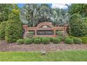 Landscaped brick entrance to Tree Tops community with signage and manicured bushes at 9818 Tree Tops Lake Rd, Tampa, FL 33626