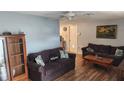 Cozy living room with comfortable sofas, wood floors, and decorative artwork at 9926 Gray Fox Ln, Port Richey, FL 34668