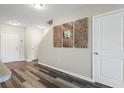 Entryway featuring durable flooring and a decorative art piece, leading to stairs and other rooms at 9960 Hound Chase Dr, Gibsonton, FL 33534