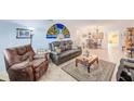 Bright and airy living room featuring tile flooring, comfortable seating, and dining space at 11200 102Nd Ave # 75, Seminole, FL 33778