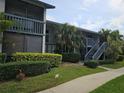 Exterior view of the condominium featuring well-maintained landscaping, stairs, and a walkway at 11201 122Nd Ave # 129, Largo, FL 33778