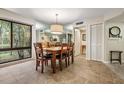 Bright dining area featuring a wooden table, seating for six, and a large window with scenic views at 11440 Harbor Way # 5009, Largo, FL 33774