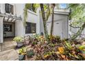 Exterior view of condo entrance adorned with tropical plants, providing privacy and a natural aesthetic at 11440 Harbor Way # 5009, Largo, FL 33774