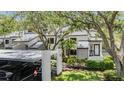 Exterior of condominium showing covered parking, mature landscaping and a welcoming entrance at 11440 Harbor Way # 5009, Largo, FL 33774