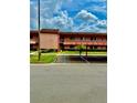 Exterior of building with covered parking, landscaping, and visible unit entrances under a cloudy sky at 141 Lakeside Dr, Oldsmar, FL 34677