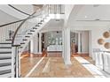 Bright, open foyer with a grand staircase, marble floors, and elegant columns leading to the living areas at 17129 Breeders Cup Dr, Odessa, FL 33556
