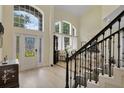 Bright foyer boasts tall ceilings and an elegant front door with sidelights at 18107 Sugar Brooke Dr, Tampa, FL 33647