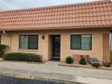 Charming condo unit featuring a red tile roof, neutral stucco, and neatly trimmed landscaping at 19029 Us Highway 19 N # 31F, Clearwater, FL 33764