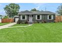 Charming home showcasing a well-manicured lawn, fresh landscaping, and inviting curb appeal at 2122 W Ferris Ave, Tampa, FL 33603