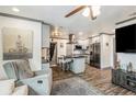 Open-concept living room featuring an island kitchen, hardwood floors, and modern gray interior at 2122 W Ferris Ave, Tampa, FL 33603