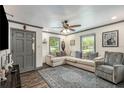 Comfortable living room with a large sectional sofa, ceiling fan, and natural light from windows at 2122 W Ferris Ave, Tampa, FL 33603