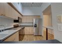 Bright kitchen with wooden cabinets, modern appliances, and a view to the dining area at 2402 Azeele W St # 412, Tampa, FL 33609
