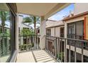 Exterior balcony with a courtyard view with mature trees and landscaping at 2597 Countryside Blvd # 206, Clearwater, FL 33761