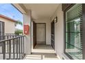 Inviting entryway showcasing the front door with modern sconce and neutral tones at 2597 Countryside Blvd # 206, Clearwater, FL 33761