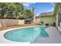 Inviting backyard featuring a refreshing pool, privacy fence, covered area and plenty of space for outdoor seating at 2816 Manor Hill Dr, Brandon, FL 33511