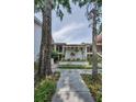 Charming condo complex exterior with mature trees and well-manicured landscaping at 300 S Florida Ave # 200J, Tarpon Springs, FL 34689