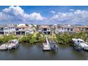 Aerial view of waterfront homes showcasing backyard docks and boat lifts, perfect for boating enthusiasts at 3122 Christophers Watch Ln, Ruskin, FL 33570