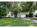 Quaint single-story house surrounded by mature trees and a spacious green lawn at 3212 56Th N Ave, St Petersburg, FL 33714