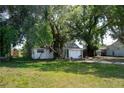 Cozy single-story home with mature trees, a lawn, and a simple walkway at 3212 56Th N Ave, St Petersburg, FL 33714