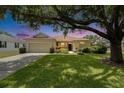 Charming single-story home with a well-manicured lawn and mature trees providing shade at 3333 Michener Pl, Plant City, FL 33566