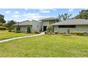 Charming single story home with lush lawn and mature landscaping at 4009 Carrollwood Village Dr, Tampa, FL 33618