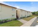 A view of a condominium complex showing a well-maintained exterior, landscaping, and easy access walkways at 4215 East Bay Dr # 1103D, Clearwater, FL 33764