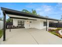 Beautifully renovated home with a covered carport, a modern front door, and colorful landscaping at 4681 70Th N Ave, Pinellas Park, FL 33781