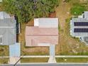 An aerial shot highlighting the house's layout, roofing, and location within the community at 5033 Tammy Ln, Holiday, FL 34690